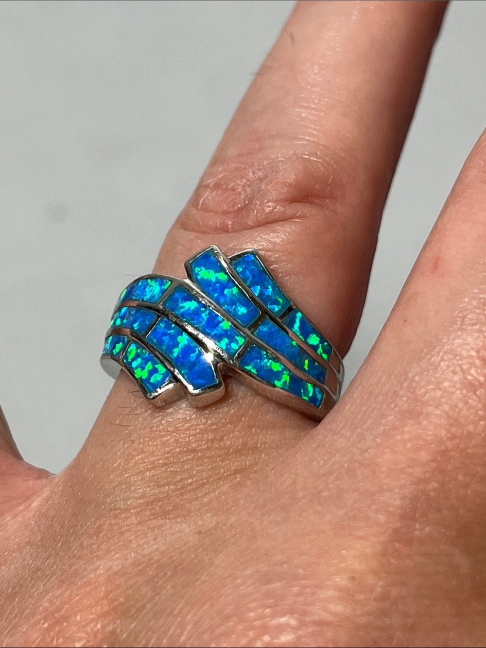 Blue Fire Opal Inlay Wave Ring
Stamped 925. Sterling Silver
Size 7.